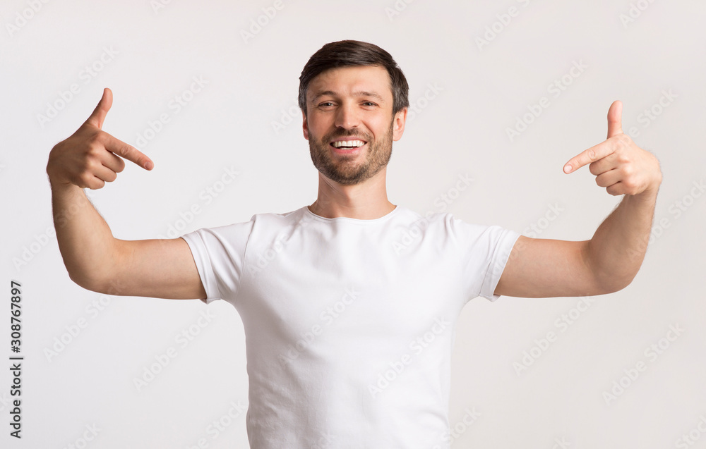 Positive Man Pointing Fingers At Himself Standing, Studio Shot Positive Man Pointing Fingers At Himself Standing, Studio Shot