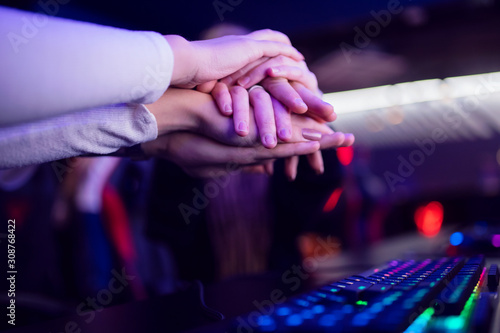 Hand of team man and girl professional gamer playing tournaments online games computer with headphones