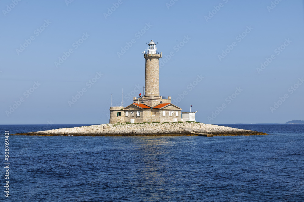old stone lighthouse on small island