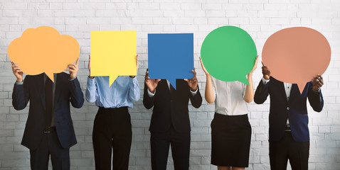 Group of corporate people hiding faces behind speech bubbles