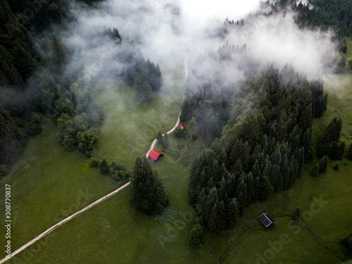 Aerial view of foggy forest,mountain road to the cabin in the wilderness. Rural nature landscape captured at ealry morning In Gerold,Germany. photo