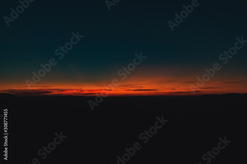 abstract horizon sunset twilight lighting dark blue and orange color unfocused surreal natural background wallpaper pattern photography with empty copy space for your text 