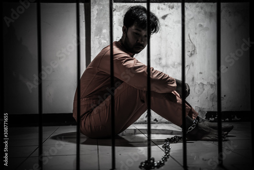 Fotografie Asian man desperate at the iron prison,prisoner concept,thailand people,Hope to