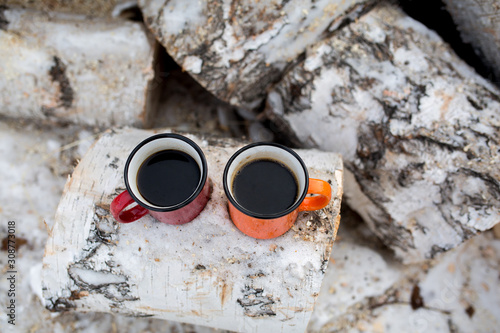 Hot coffee in cozy mugs. Winter season. Picnic in the nature.