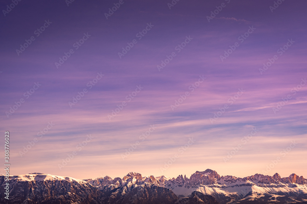 Snowy rocky mountain with a beautiful pink sunset, space fort text