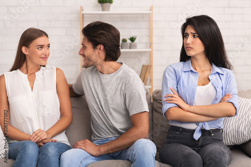 Slika na platnu Girl Looking At Boyfriend Flirting With Woman Sitting On Sofa