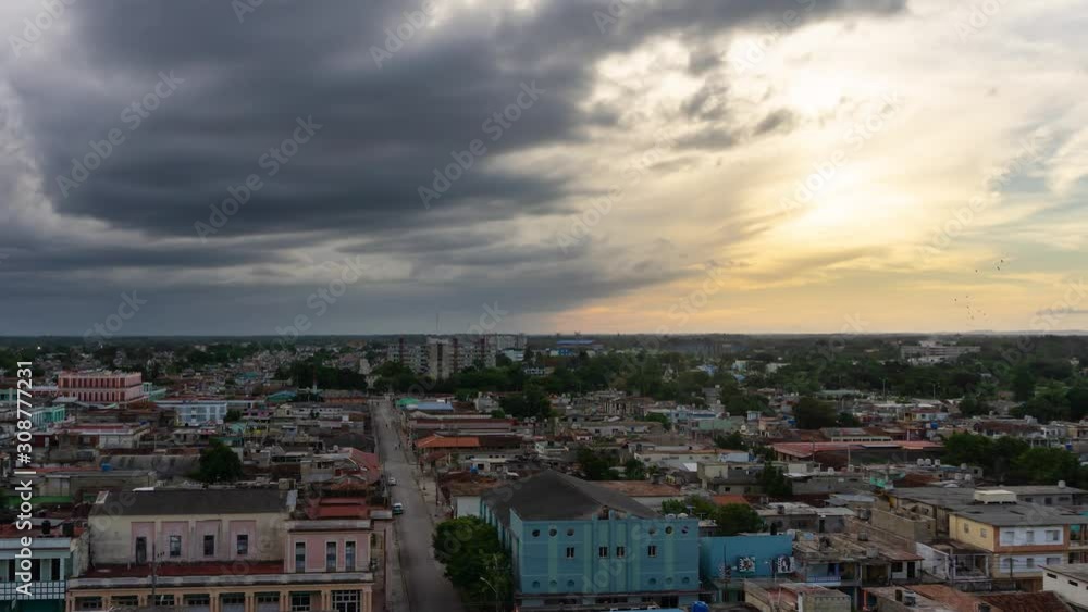 Time Lapse of an Aerial Panoramic view of a small Cuban Town, Ciego de Avila, during a cloudy and colorful sunset. Located in Central Cuba. Time Lapse of an Aerial Panoramic view of a small Cuban Town, Ciego de Avila, during a cloudy and colorful sunset. Located in Central Cuba.