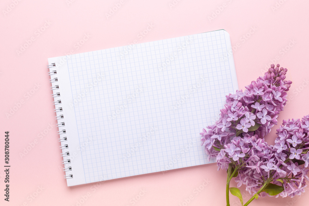 Lilac and notepad on pink background. Still life. Spring romantic mood. Top view. Copy space Lilac and notepad on pink background. Still life. Spring romantic mood. Top view. Copy space