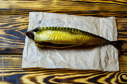 raw dried mackerel fish on a wooden table, top view, selective focus photo