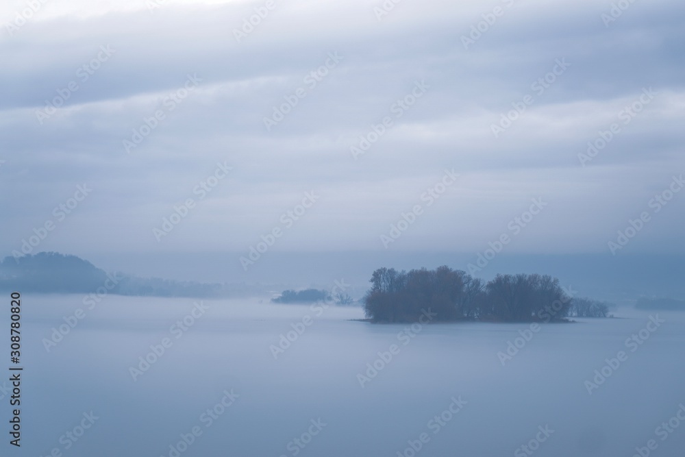 Island in the river with fog