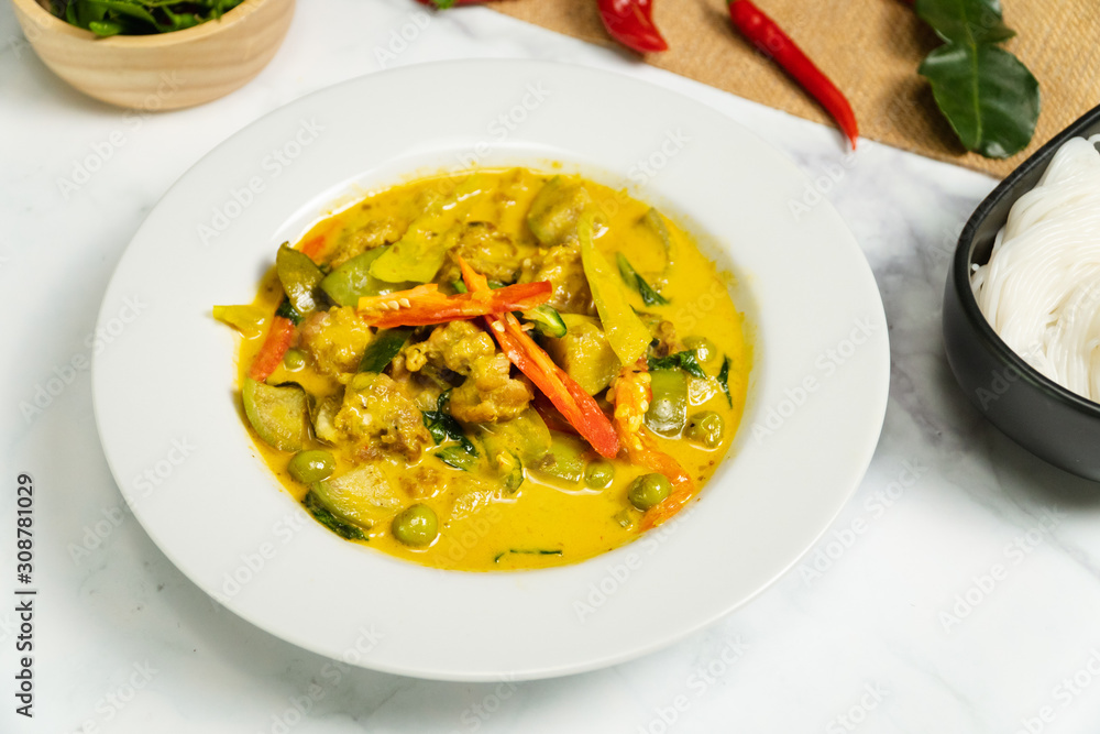 Green curry traditional Thai food name in Thai is Gaeng Kiew Waan in white round ceramic plate Green curry traditional Thai food name in Thai is Gaeng Kiew Waan in white round ceramic plate