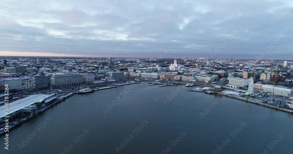 Aerial view Of Helsinki city from the sea. Sunset Evening Illuminations. Scenic winter view of the Old town. Finland. 4K Aerial view Of Helsinki city from the sea. Sunset Evening Illuminations. Scenic winter view of the Old town. Finland. 4K