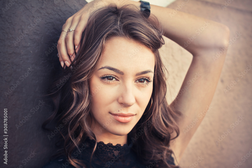 Fototapeta premium Portrait of beautiful brunette woman in black dress. Fashion photo