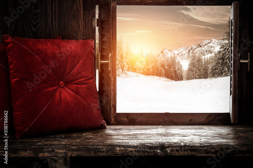 Wooden window sill with pillows and sunny  december day. 