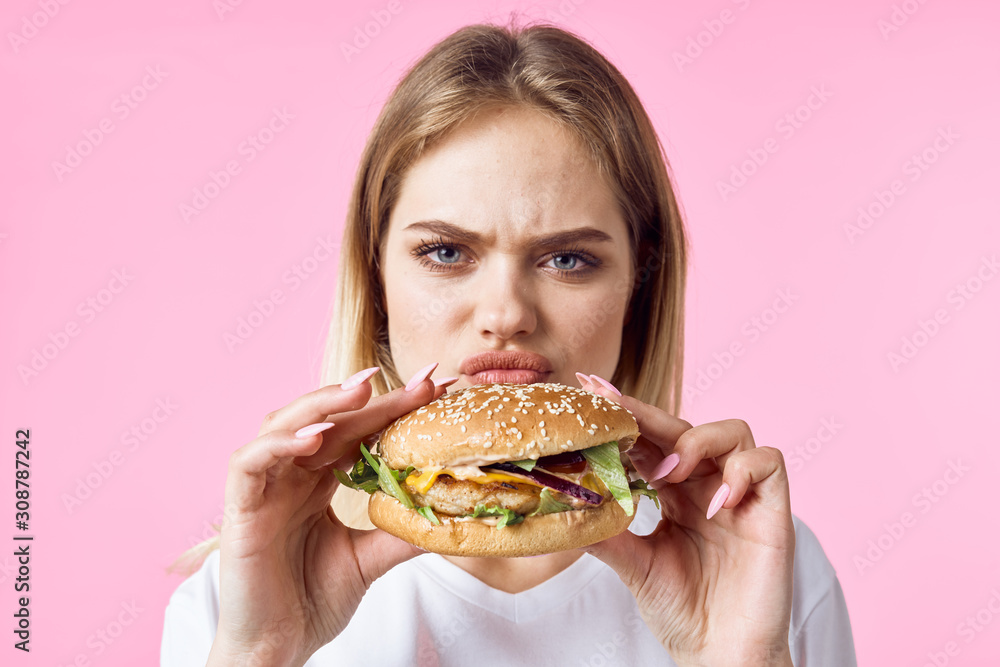 woman with hamburger and french fries woman with hamburger and french fries