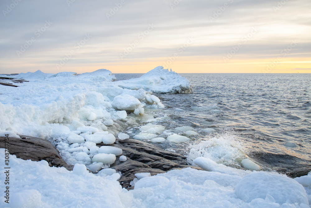 Winter coastal landscape with ice and snow on the beach. Pori, Finland. Winter coastal landscape with ice and snow on the beach. Pori, Finland.