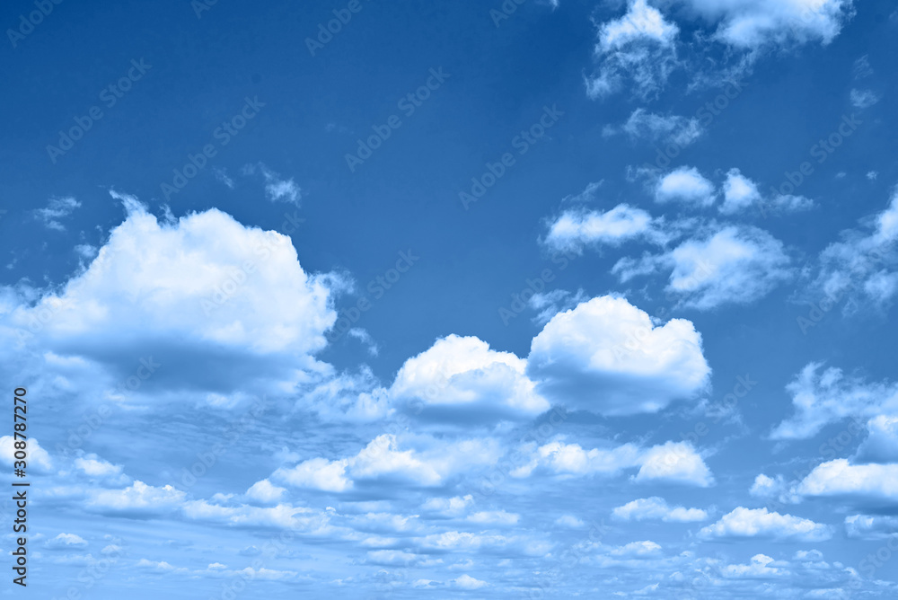 Classic blue background. Sky with clouds, copy space. Color of the year 2020. Nature heaven background