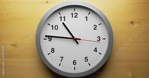 Still shot of time-lapse gray clock with black arrows shows motion the time speed from 10.00 to slow down 12.00, How time flies concept.
