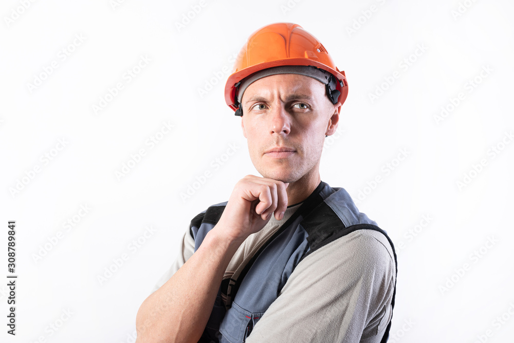 The builder thought. In work clothes and hard hat. The builder thought. In work clothes and hard hat.