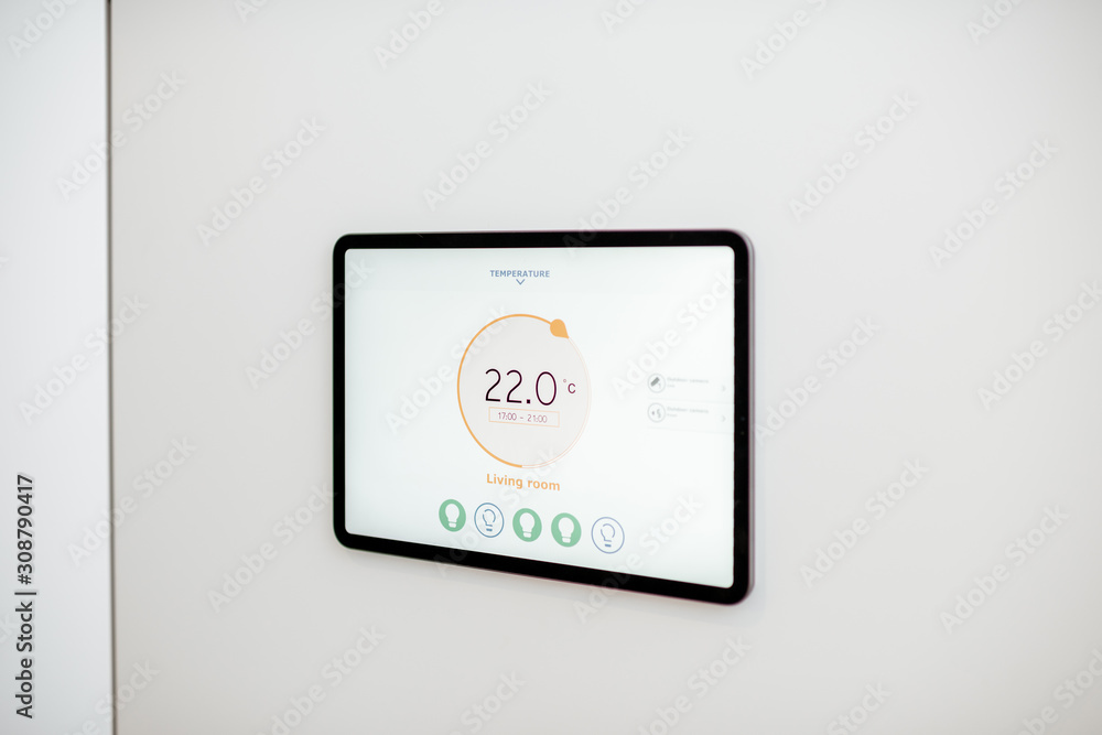 Fototapeta premium Digital touch screen panel for smart home managing with launched heating control application installed on the wall