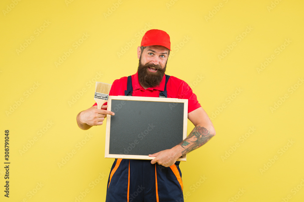 Man worker with paint brush. Builder regular worker. Repair and renovation. Quick repair. Creative decorator. Painting works. Bearded decorator hold chalkboard advertisement copy space. Repair tips Man worker with paint brush. Builder regular worker. Repair and renovation. Quick repair. Creative decorator. Painting works. Bearded decorator hold chalkboard advertisement copy space. Repair tips