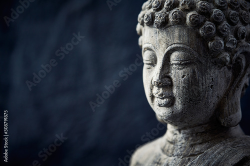 Meditating Buddha Statue on dark background. Copy space.  © Eugeniusz Dudziński
