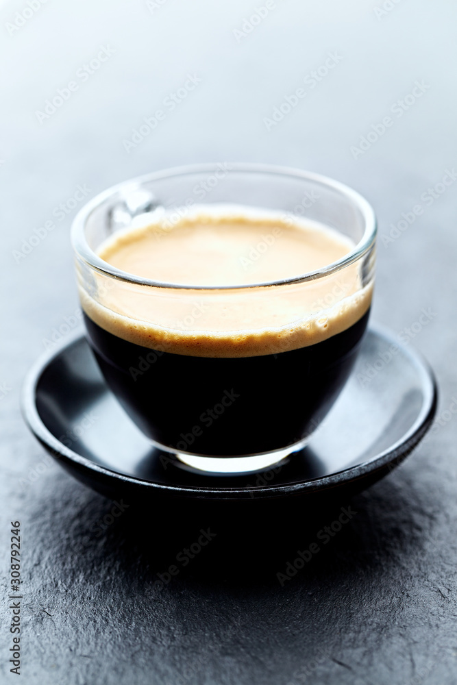 Coffee in glass cup on stone background. Close up. Coffee in glass cup on stone background. Close up.