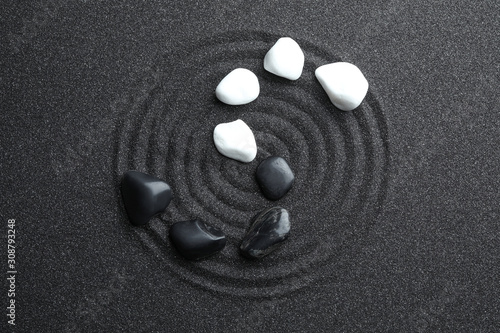 Photography Stones on black sand with beautiful pattern, flat lay