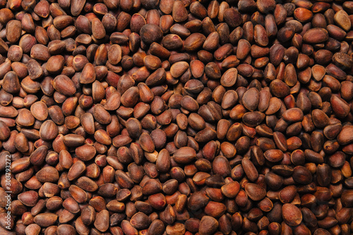 Pine nuts. Textured background for wallpaper.