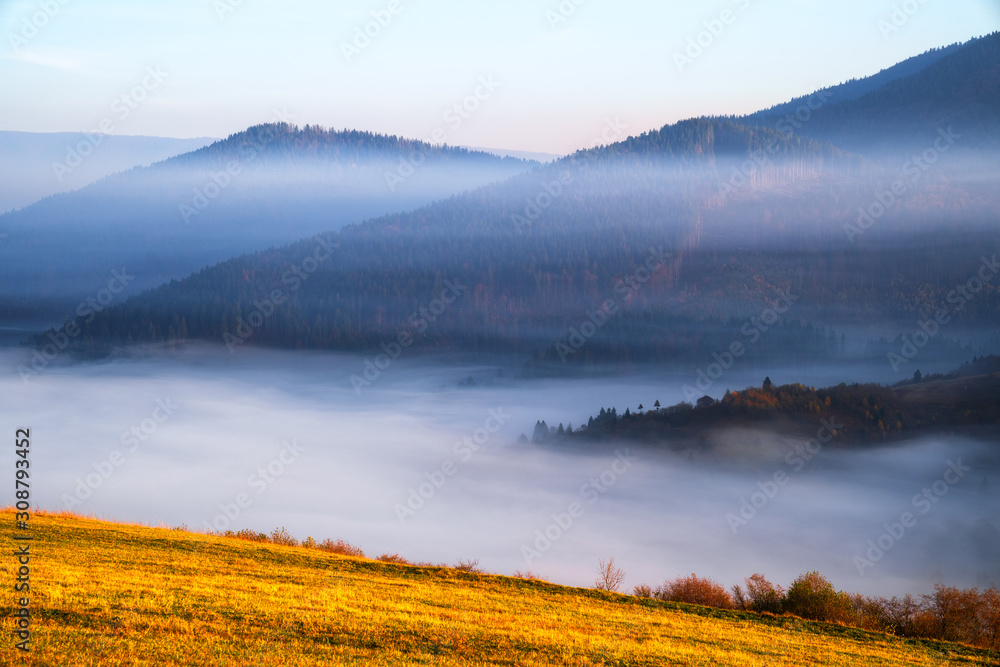 Mountain hills covered with fog