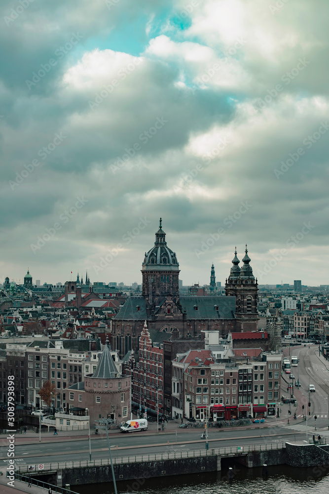 Obraz premium Old centre of the city of Amsterdam under cloudy sky in autumn. High angle view.