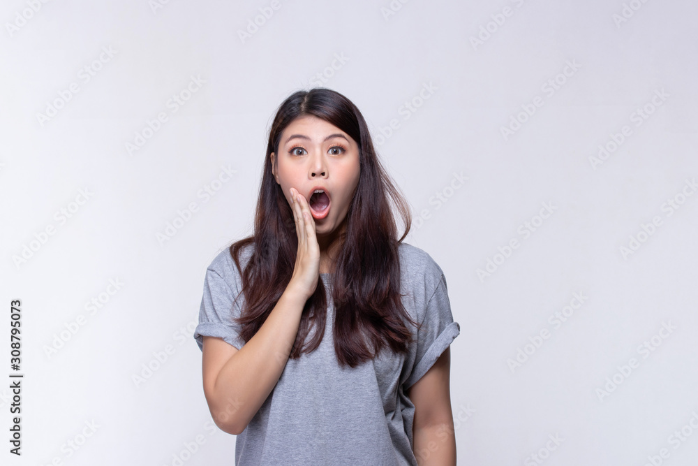 Image of feeling excited, shock, surprise and happy. Young asian woman standing on white background. Female face expressions and emotions body language concept. Image of feeling excited, shock, surprise and happy. Young asian woman standing on white background. Female face expressions and emotions body language concept.