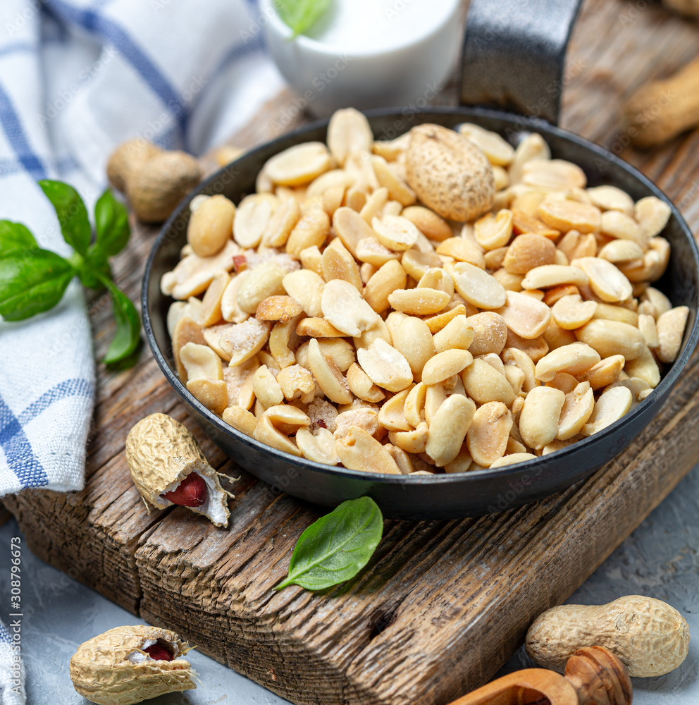 Roasted peanuts with salt in the pan. Roasted peanuts with salt in the pan.