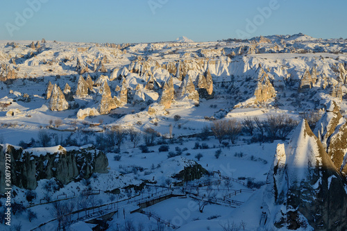 Winter snowy sunset view of Cappadocia in Goreme, beautiful rock formations