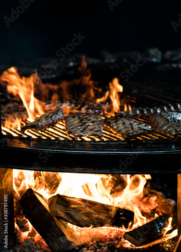 .rib restaurant, the process of preparing pork ribs on an open fire