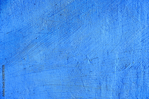 blue paint texture of old building wall with scratches and scuffs