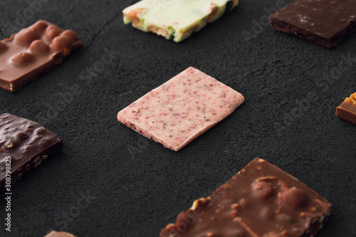 Сhocolate plates flat lay view on dark background, top of view