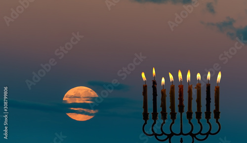 Menorah with light of candles is traditional symbol for Hanukkah Holiday