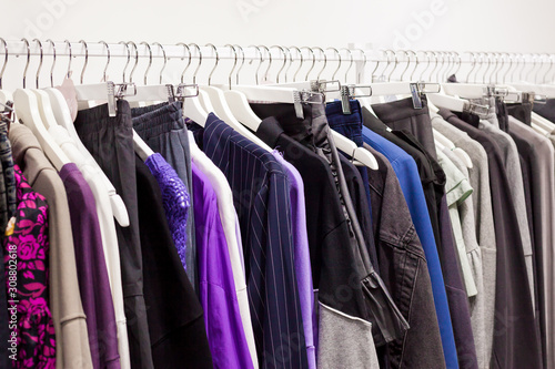 Wallpaper Mural Close-up of colorful casual women's clothing hanging on white wooden hangers in a fashion store in a shopping mall.  Seasonal sales, Retail, Black Friday Shopping
 Torontodigital.ca