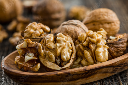 Handful of Walnuts on wooden background photo