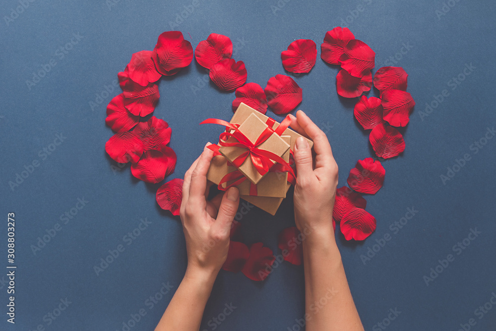 Valentines Day. Gift boxes  craft paper and red ribbon classic blue background, holiday concept, wedding invitations, birthday cards and mothers day. Long banner, zero waste, eco friendly packaging.