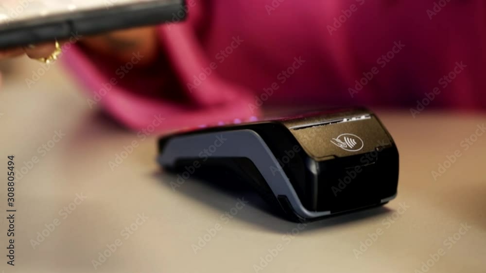 Woman holds wi-fi compact payments terminal. Woman holds wi-fi compact payments terminal.