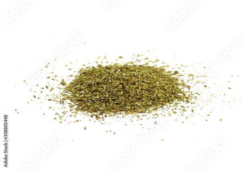 Dry marjoram spice (Origanum majorana). Heap of ground marjoram leaves isolated on white.