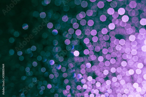 Defocused rain drops on the window shining in the dark
