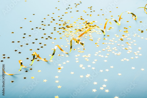 Golden stars on blure background. Flat lay, top view.