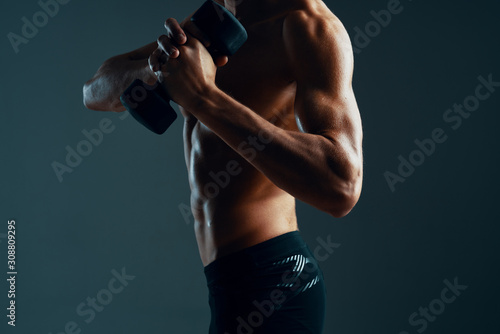 young man exercising with dumbbells