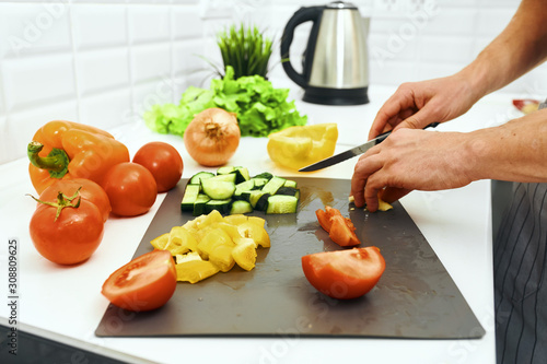 woman cutting vegetables in kitchen