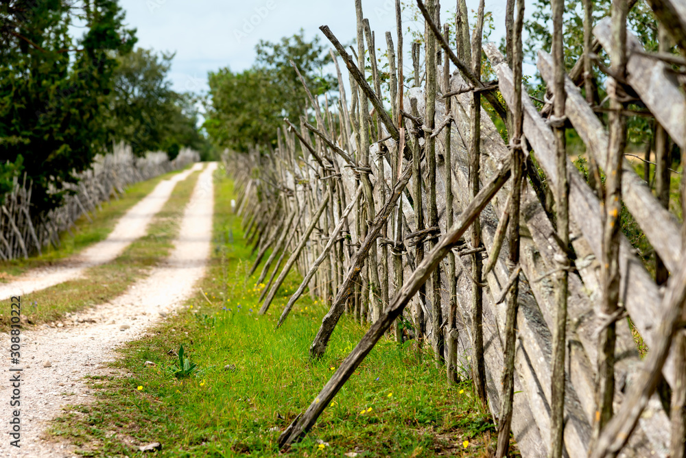 Fototapeta premium Old traditional wooden fence on the island Gotland, Sweden, along a country road