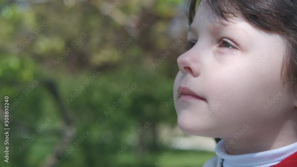 Portrait of a cute child. Robot vacuum cleaner at work. Portrait of a cute child. Robot vacuum cleaner at work.