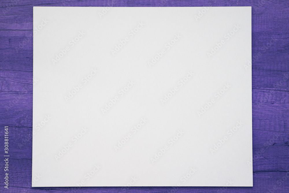 White mock up on a painted in violet wooden background. White mock up on a painted in violet wooden background.